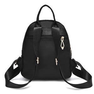 Mini sac à dos noir imperméable pour femme avec détails dorés et poche arrière antivol