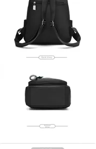 Detail view of the black backpack showing rear anti-theft pocket and bottom structure