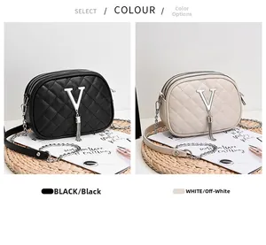 Close-up of quilted crossbody bag featuring triple zippers and metallic V logo detail