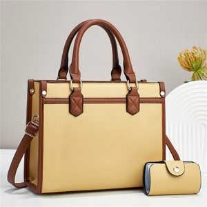 Detail of retro color-block tote bag with matching pouch and premium gold-tone hardware