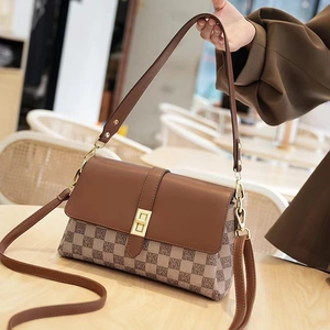Detail of vintage crossbody bag with MS monogram canvas and brown leather strap