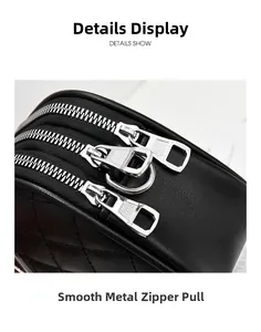 Macro detail of three smooth silver metal zippers on black quilted faux leather crossbody bag