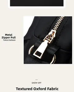 Detailed close-up of premium gold hardware puller and textured black oxford fabric