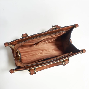 Top view of brown tote bag interior showing multiple zipper compartments and large capacity
