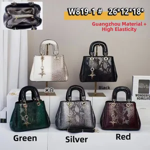 Detail view of large snake pattern leather tote bags with star charm and interior pockets