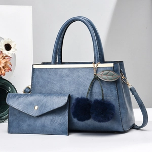 Blue composite leather tote set with envelope clutch and cherry pompom detail