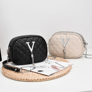 Quilted crossbody bags with V-shaped metal buckle and tassel in black and beige