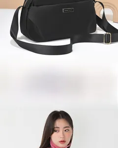 Detail of adjustable strap and golden buckle on a black nylon crossbody bag for women