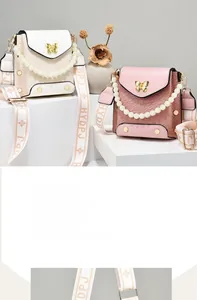 Detail of woven texture phone bags with pearl handles and gold butterfly clasps