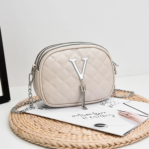 Quilted cream crossbody bag with silver V-logo, metal tassel and dual zipper layers