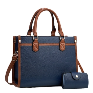 Navy blue and brown leather tote bag set with matching coin purse and shoulder strap