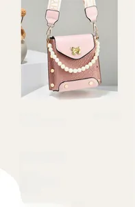Pink mini crossbody bag featuring woven texture, butterfly hardware, and a pearl strap
