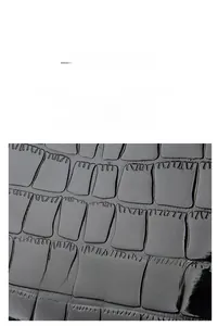 Close-up of premium black cowhide leather featuring detailed crocodile embossed texture