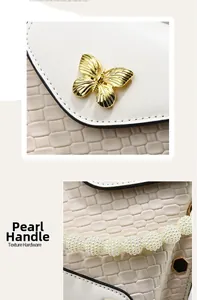 Detail of cream woven leather mini bag with pearl handle and golden butterfly clasp