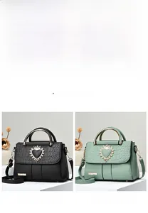 Detail of elegant crocodile texture handbags with heart-shaped crown locks and metal handles