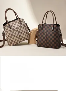 Close-up of checkerboard pattern handbag featuring dual handles and metallic hardware details