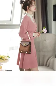 Detail of brown crocodile pattern shoulder bag with golden butterfly and pearl handle