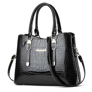 Glossy black crocodile pattern handbag with golden logo and adjustable shoulder strap