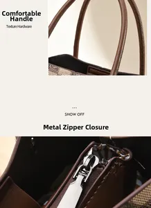 Detail view of smooth leather handle and gold-tone zipper on checkered tote bag