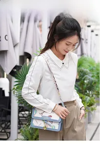 French style crossbody bag with floral strap and Eiffel Tower print outdoor view
