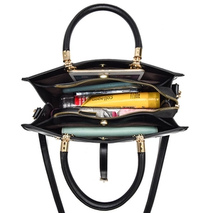 Black woven leather tote bag with three compartments and gold hardware for daily storage