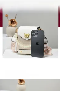 Detail of crossbody phone bag with pearl strap, golden butterfly buckle and ivory weave