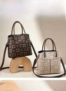 Detail view of tote bags in dark brown and beige with geometric pattern and detachable straps