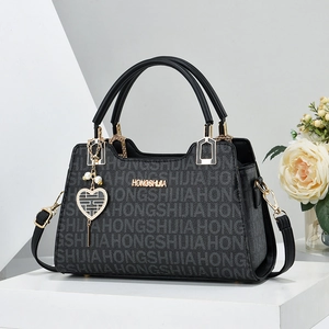 Large black tote bag with letter print pattern and elegant heart pearl charm detail