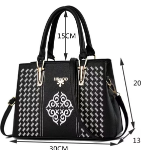 Detailed view of black embroidered handbag with dimensions 30cm length and 20cm height