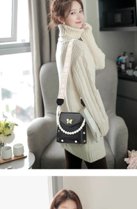 Detail of black crocodile texture bag with golden butterfly buckle and pearl chain