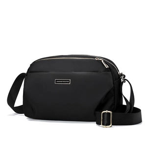 Women's black nylon multi-layer crossbody bag with gold hardware shown at a 45-degree angle