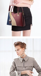 Detail of color-block leather handbag with butterfly pendant and brand lettering logo