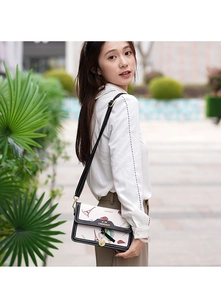 Detail of crossbody bag with French Eiffel Tower prints and elegant metal clasp buckle