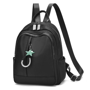 Fashionable black nylon backpack with multi-zipper compartments and star charm accessory