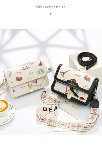 Detail of travel-themed small square bags with Eiffel Tower print and wide canvas straps