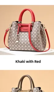 Detail view of khaki monogram pattern handbag with red woven handles and metal charm