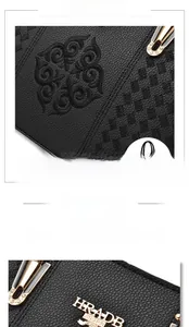 Close-up of black lychee grain leather with exquisite floral embroidery and gold hardware