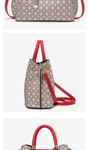 Detailed view of beige vintage patterned handbag with red handles and gold lock