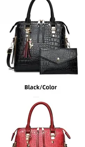 Detail of crocodile pattern leather tote bag with tassel charm and matching wallet set