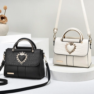 Fashionable women's embossed leather handbag set in classic black and cream white colors