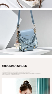 Detail of light blue crossbody phone bag with monogram pattern and plush charm