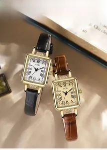 Detail of vintage rectangular women's watches with leather straps and gold cases