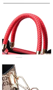 Close-up of red woven leather handle and gold hardware on monogram handbag