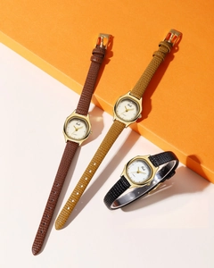 Three vintage quartz watches with patterned leather straps and gold octagonal bezels