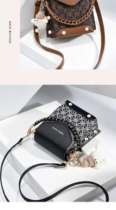 Close-up of stylish mini crossbody bags with chain handles and cute monster charms