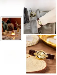Detail of vintage oval gold watch with brown crocodile leather strap and sunray dial texture