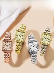 Macro shot of elegant square Roman numeral dial and luxury metal link strap on watches