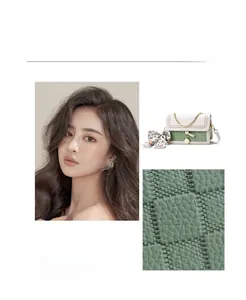 Detail of color-block shoulder bag featuring woven green flap and golden chain strap
