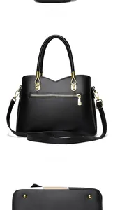 Detailed views of a black soft leather handbag with gold hardware and protective base studs