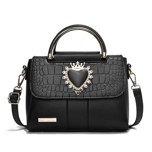 Black leather handbag with crocodile pattern flap and golden crown heart clasp